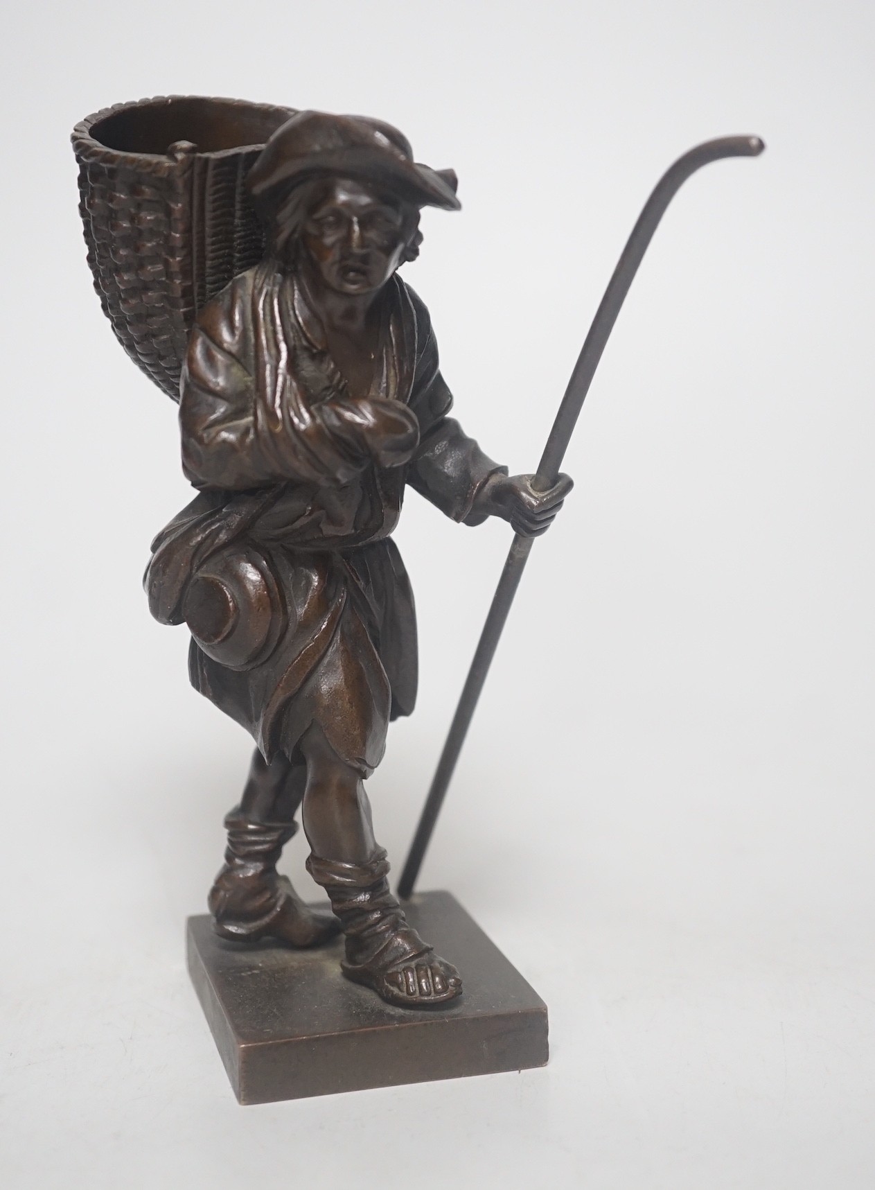 A 20th century bronze of a travelling salesman. 15cm tall